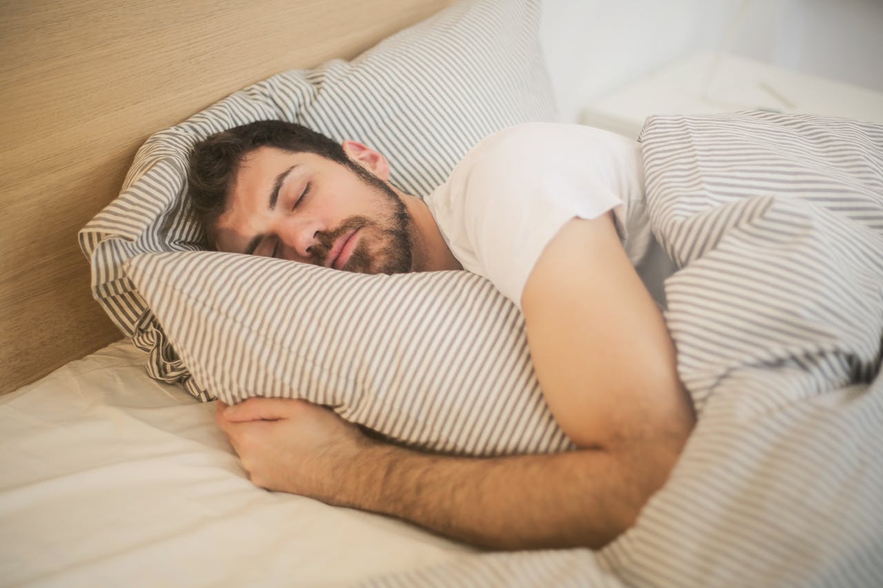 Man sleeping peacefully in bed after evening exercise