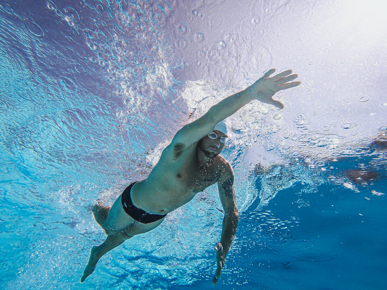 Swimmer training underwater in a pool