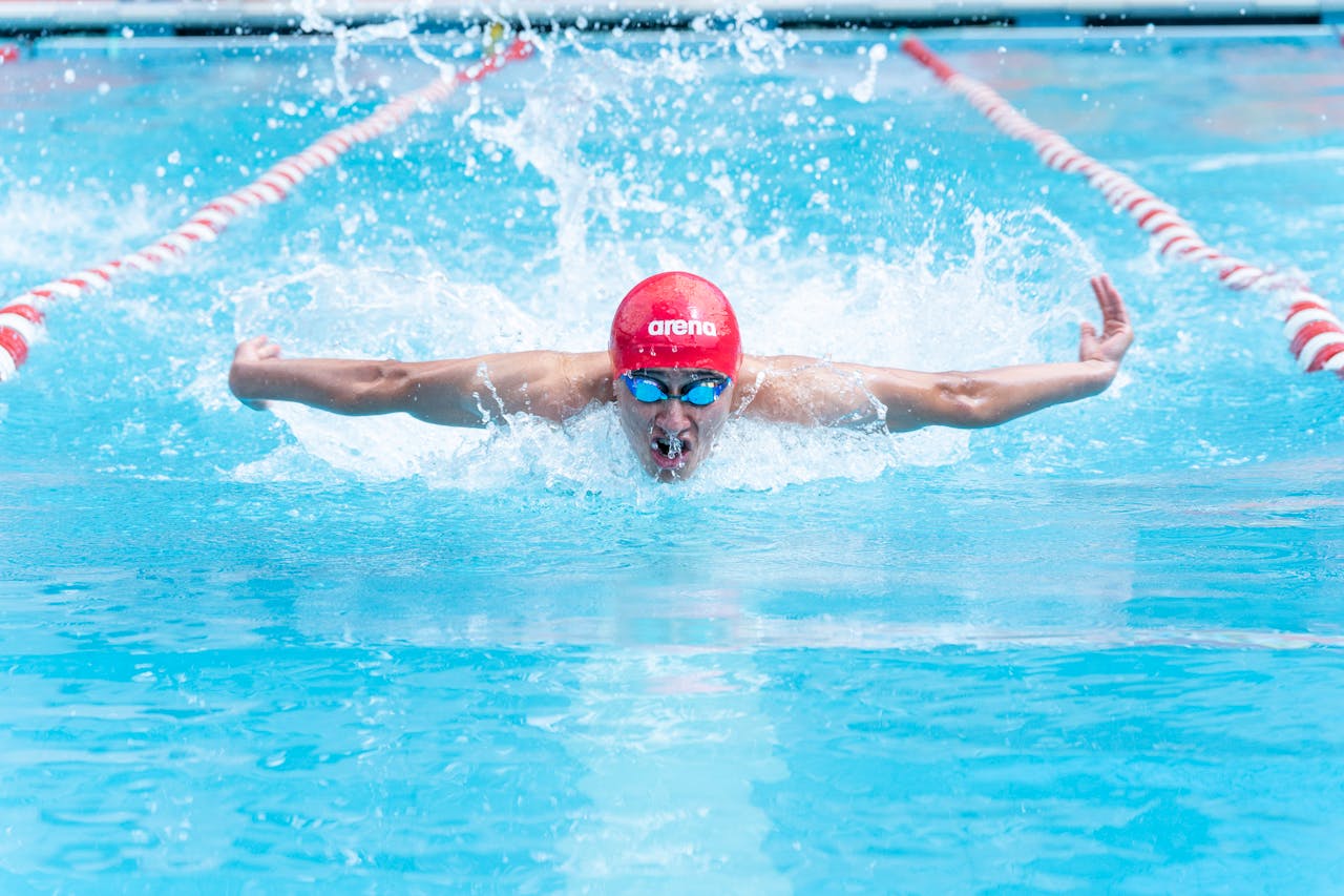 Man swimming laps in an outdoor pool